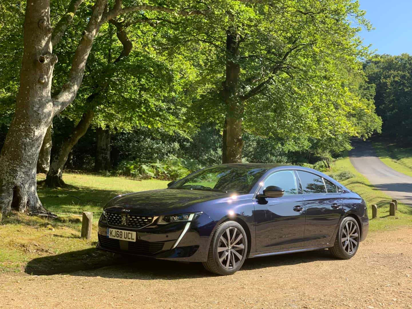 Elegant Silver Peugeot 508 Cruising On Highway Wallpaper