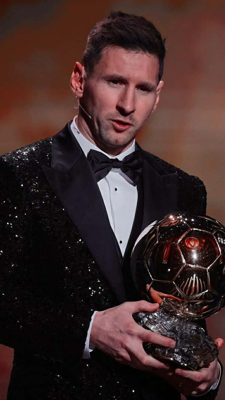 Elegant Soccer Star Holding Trophy Wallpaper