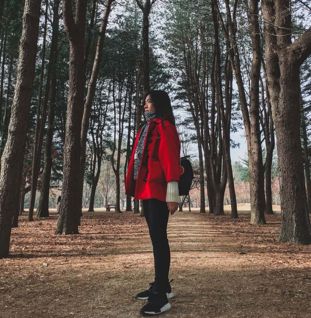 Elegant Woman Wearing A Vibrant Red Coat Wallpaper