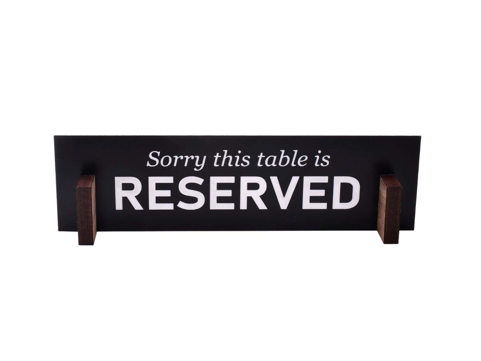 Elegant Wooden Reserved Sign On A Restaurant Table Wallpaper