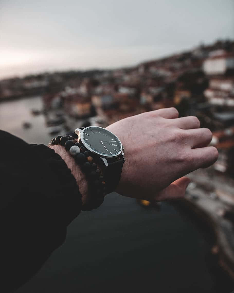 Elegant Wristwatch Overlooking Cityscape Wallpaper