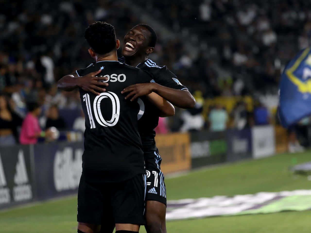 Emanuel Reynoso Hugging Teammate Wallpaper