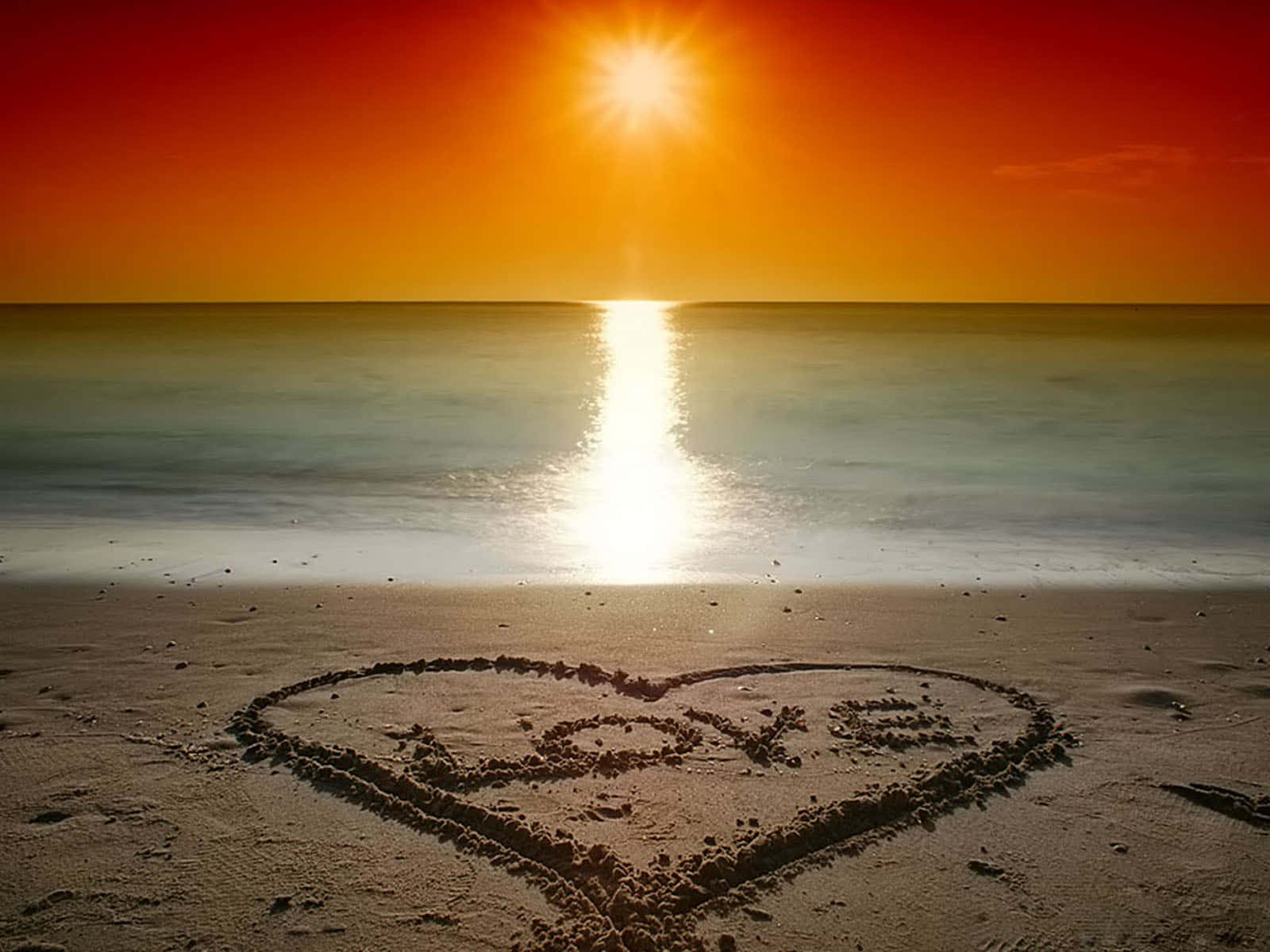 Embrace The Romantic Sunset On The Beach Wallpaper