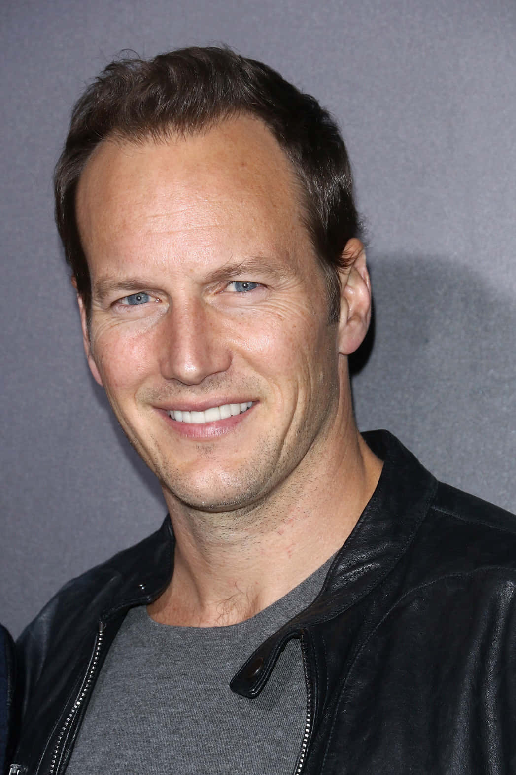 Emmy Nominee Patrick Wilson Smiling Intimately For The Camera Wallpaper