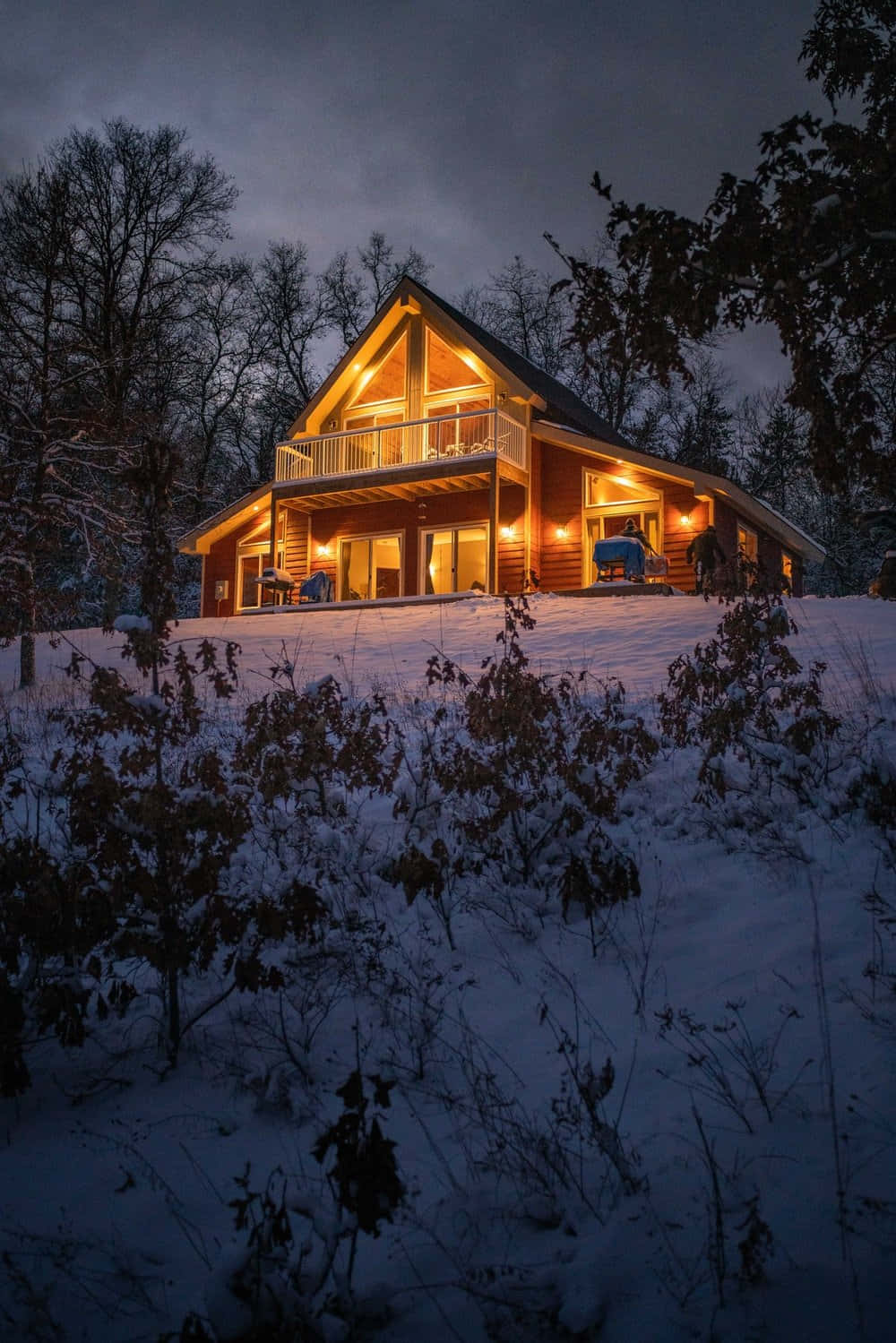 Enchanting Cozy Winter Cabin Nestled In Snowy Forest Wallpaper