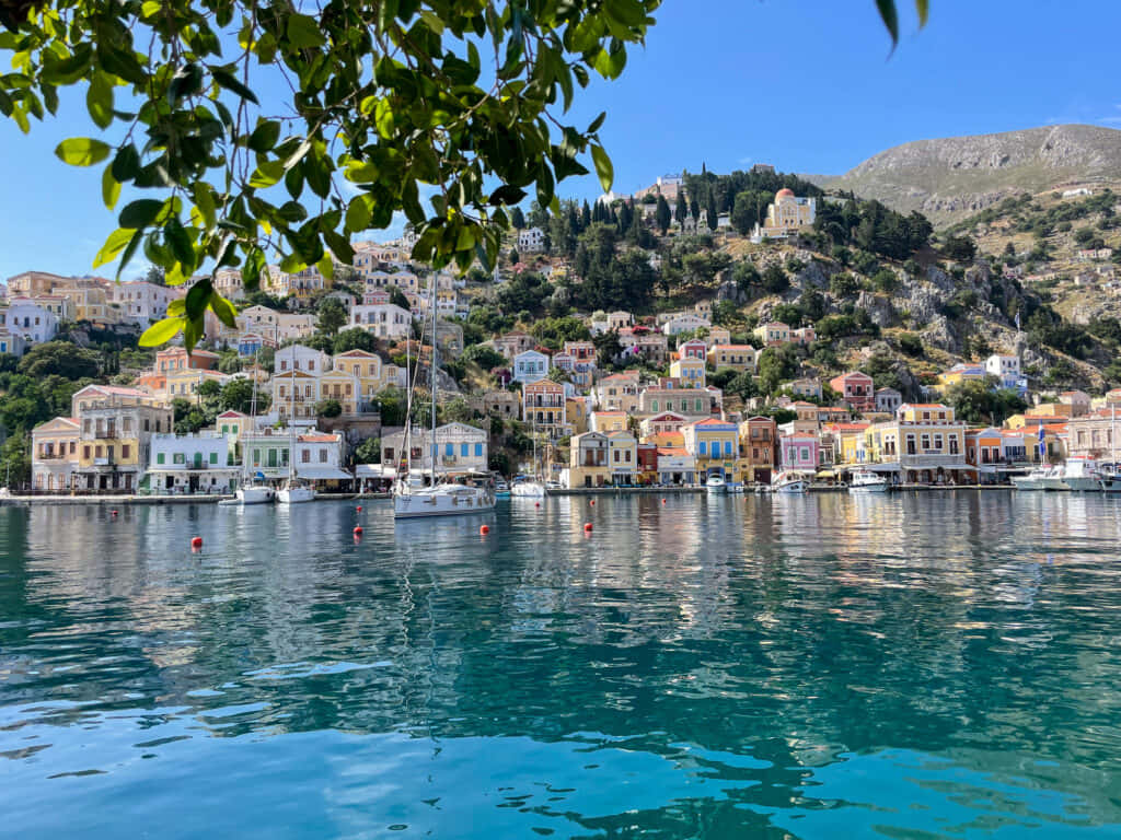 Enchanting View Of A Greek Island Village By The Sea Wallpaper