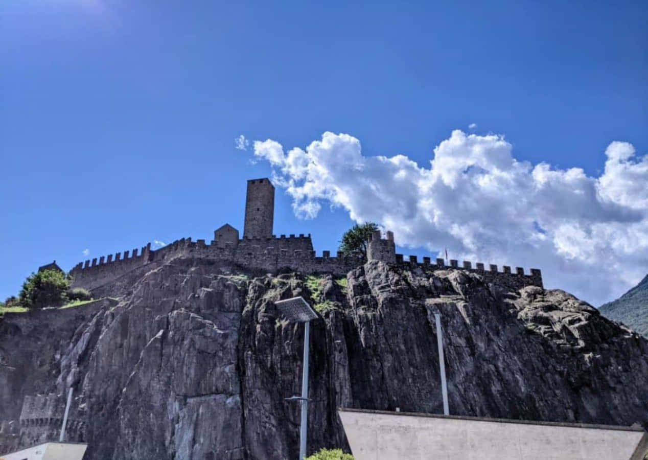 Enchanting View Of Bellinzona Castle Amidst Majestic Alpine Peaks Wallpaper