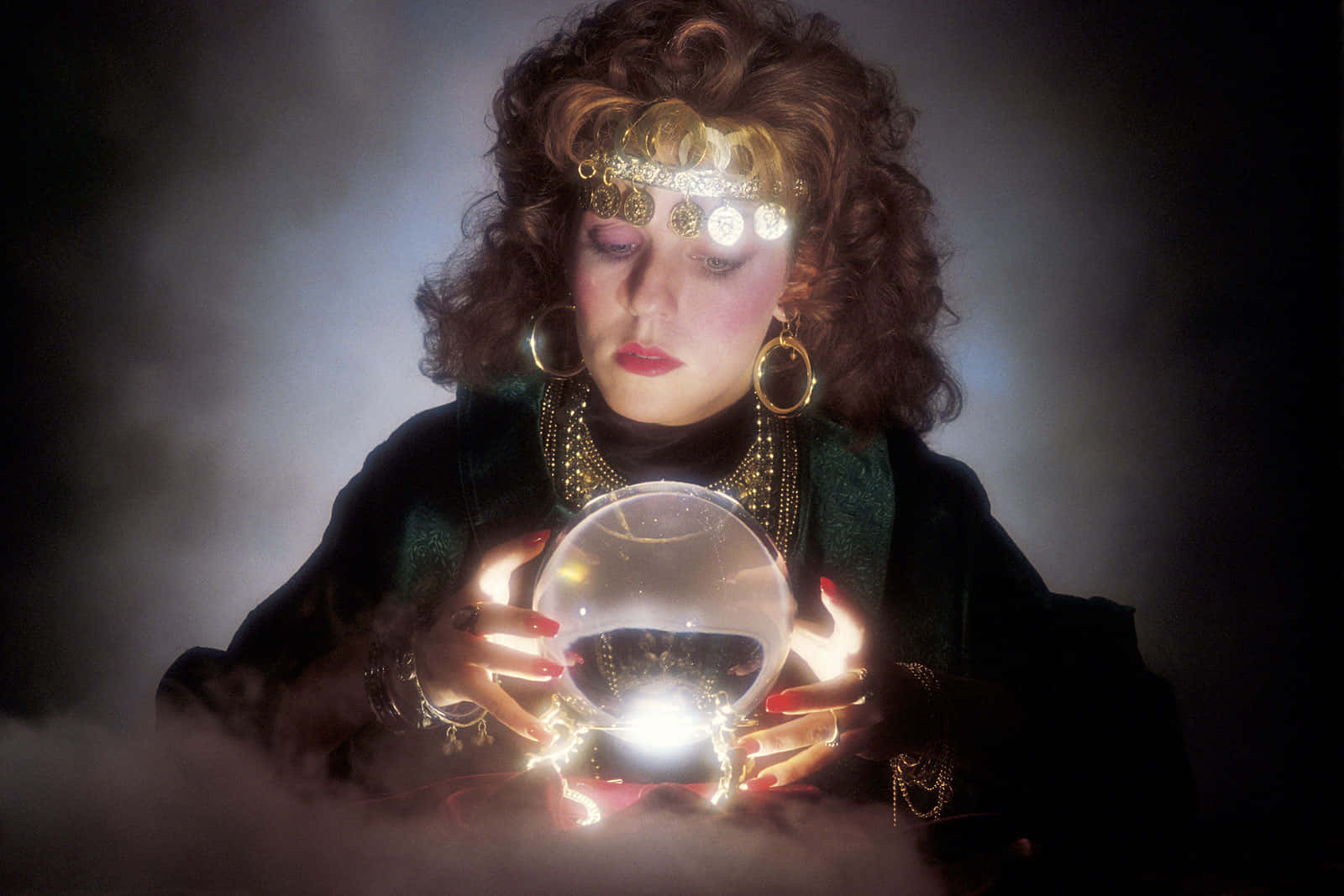 Enigmatic Fortune Teller Gazing Into Crystal Ball Wallpaper