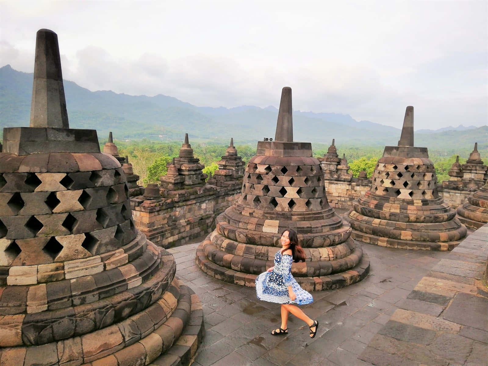 Enigmatic Smile At The Historic Borobudur Temple Wallpaper