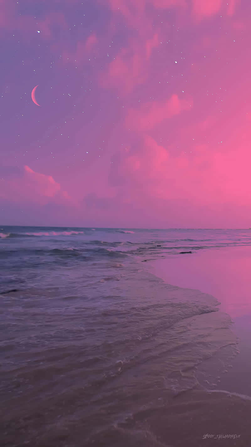 Enjoy A Beautiful Beach Sunset With A Pink And Tranquil Aesthetic. Wallpaper