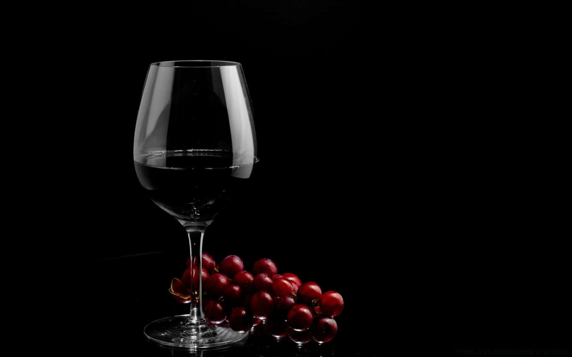 Enjoy A Glass Of Refreshing Black Wine Wallpaper