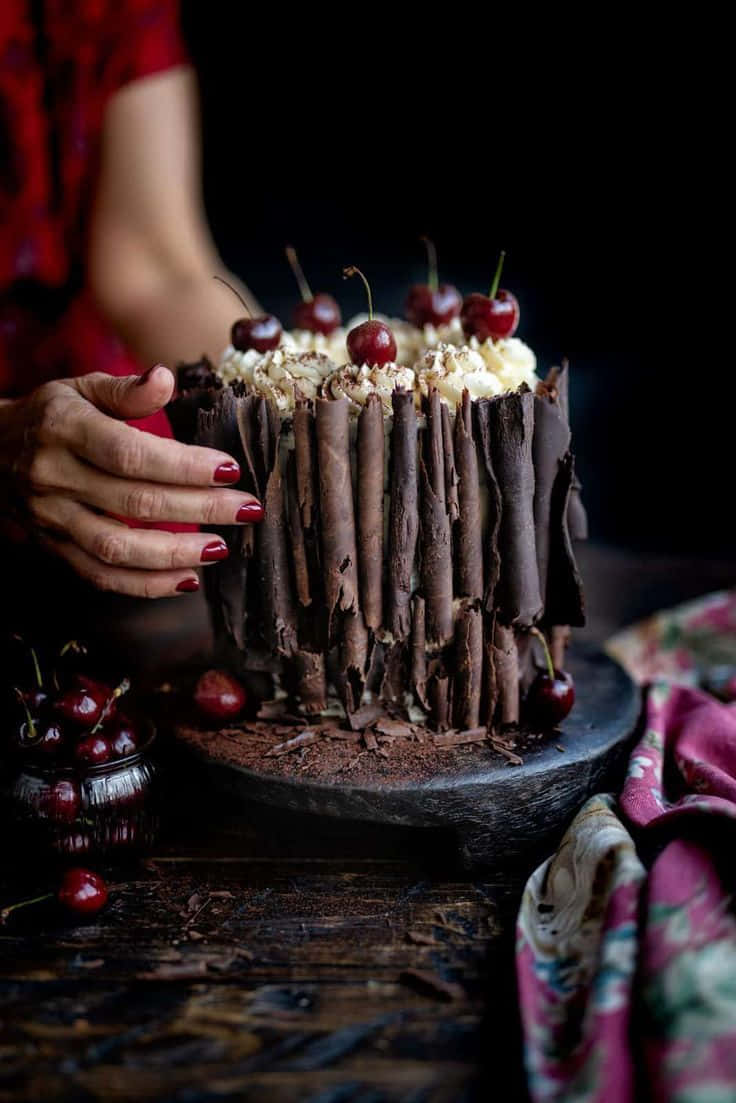 Enjoy Delectable Layers Of Chocolate Sponge Cake, Cream, Cherries And Chocolate Shavings With A Black Forest Cake! Wallpaper