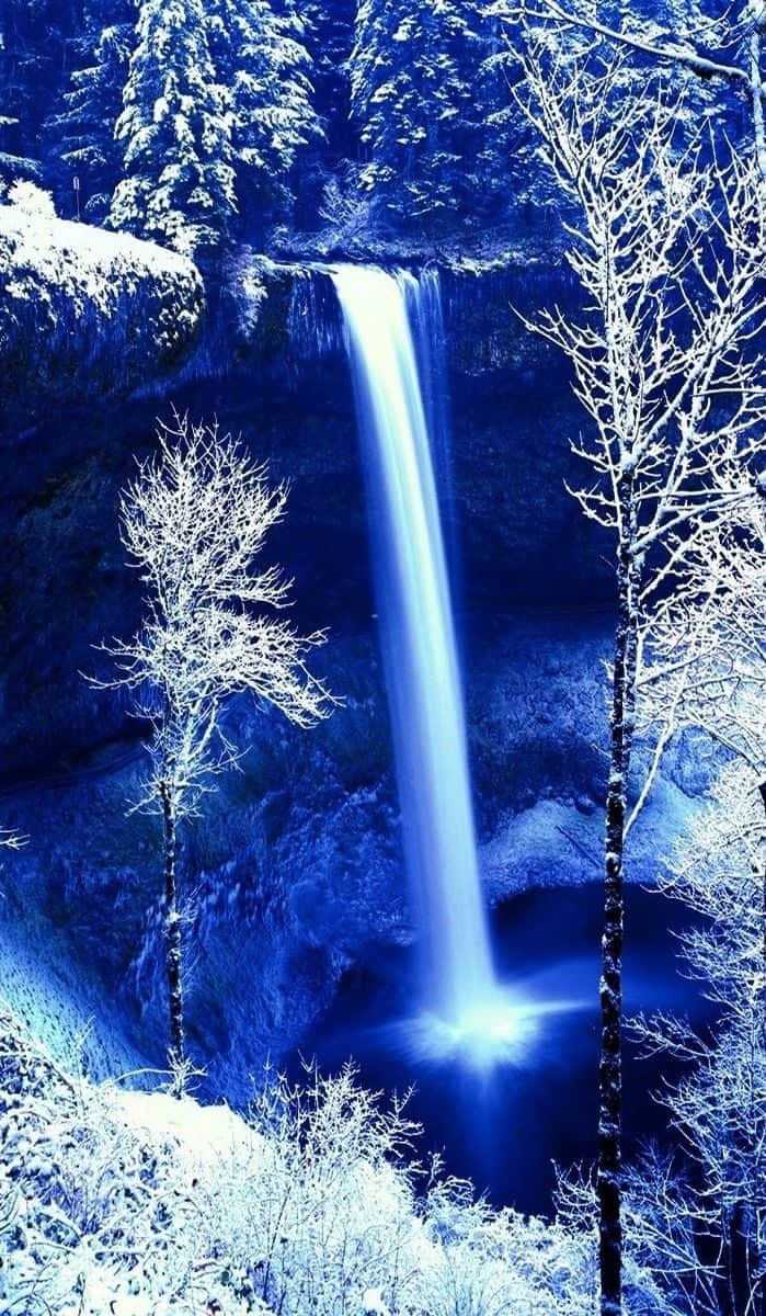 Enjoying Nature's Beauty - An Iphone Photograph Of A Waterfall Wallpaper