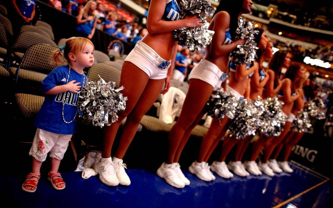 Enthusiastic Toddler Cheerleader In Action Wallpaper