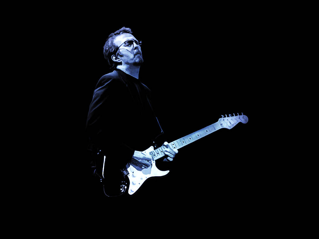 Eric Clapton Illuminated By Blue Stage Lights Wallpaper