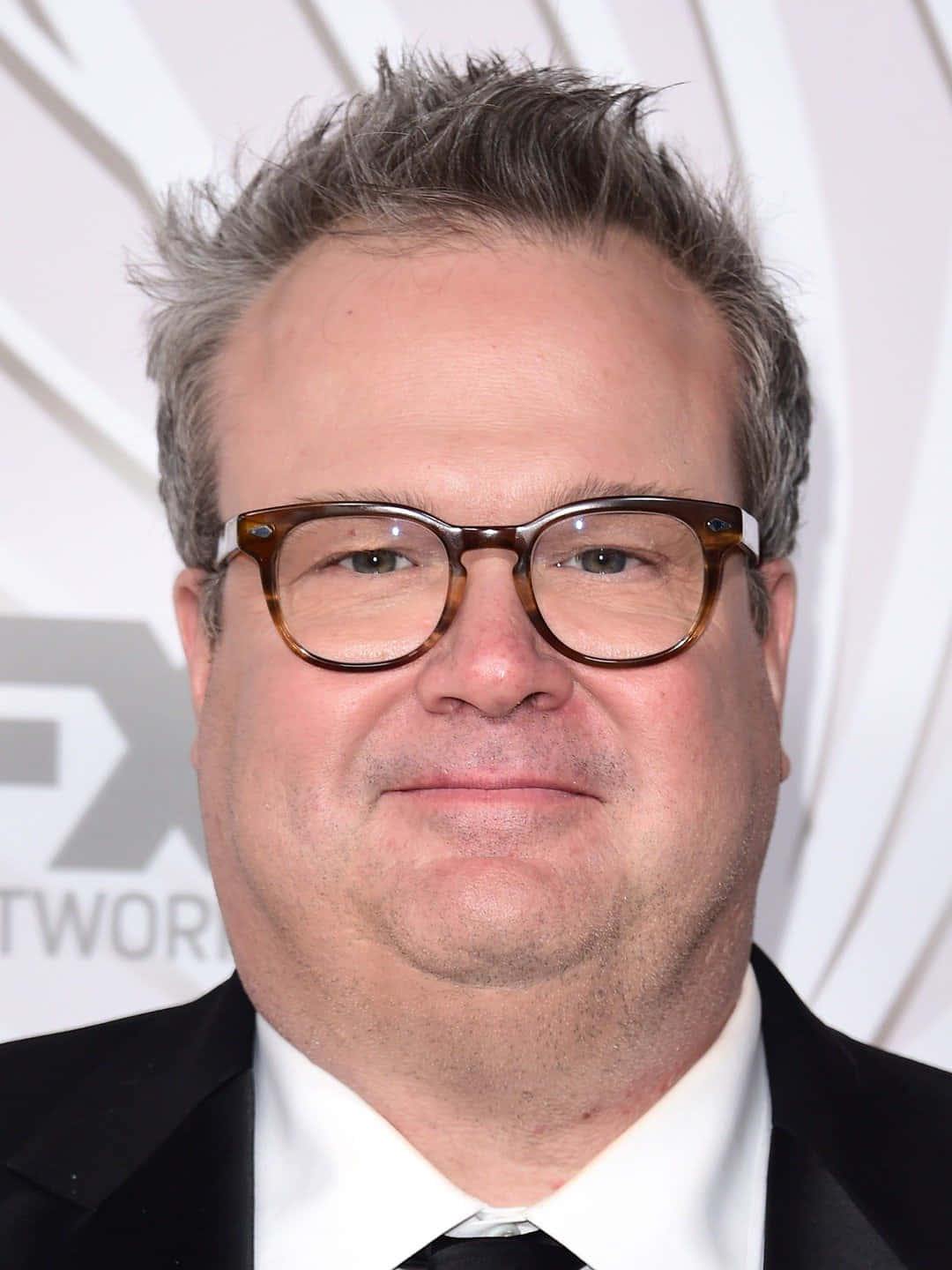 Eric Stonestreet, Star Of Modern Family, Smiling Brightly Wallpaper