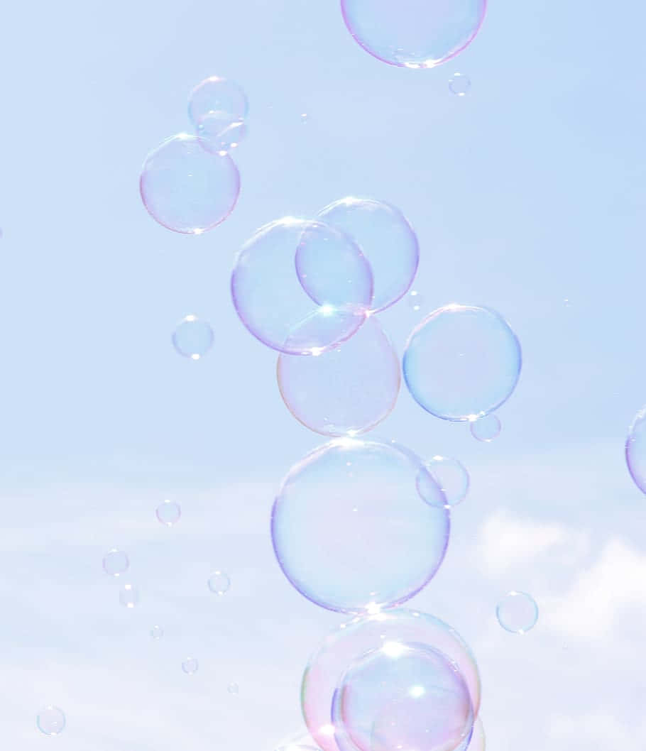 Ethereal_ Soap_ Bubbles_ Against_ Sky Wallpaper