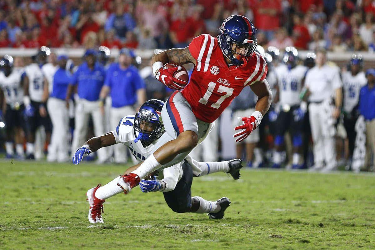 Evan Engram Evading Tackle During Game Wallpaper