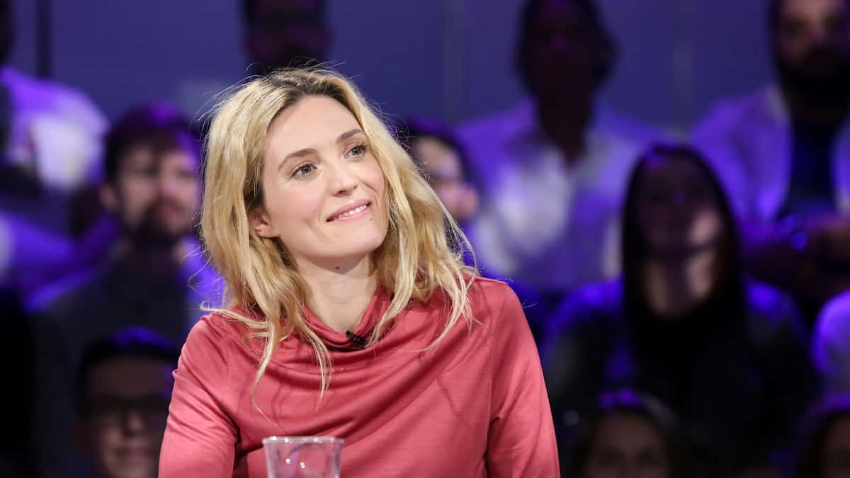 Evelyne Brochu Smiling During Interview Wallpaper