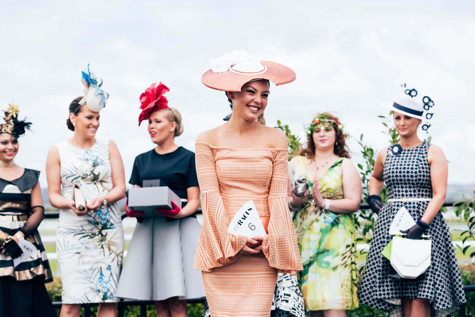 Excited Melbourne Cup Day Spectators Cheering From The Stands. Wallpaper