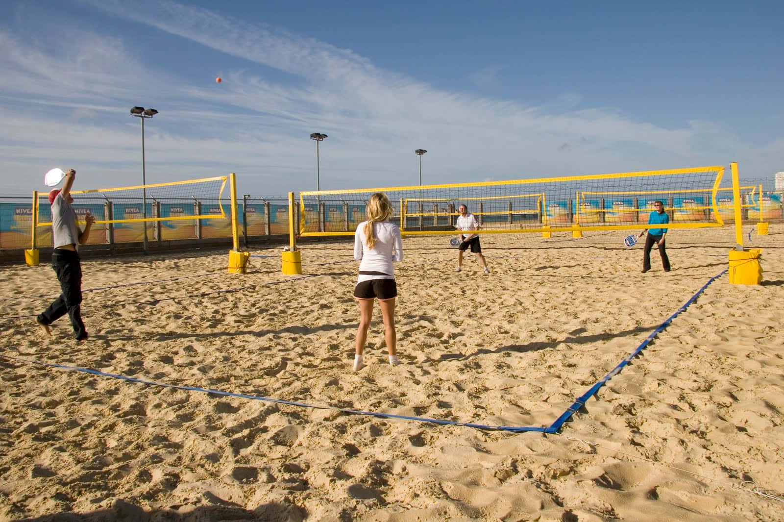 Exciting Beach Tennis Match In Progress Wallpaper