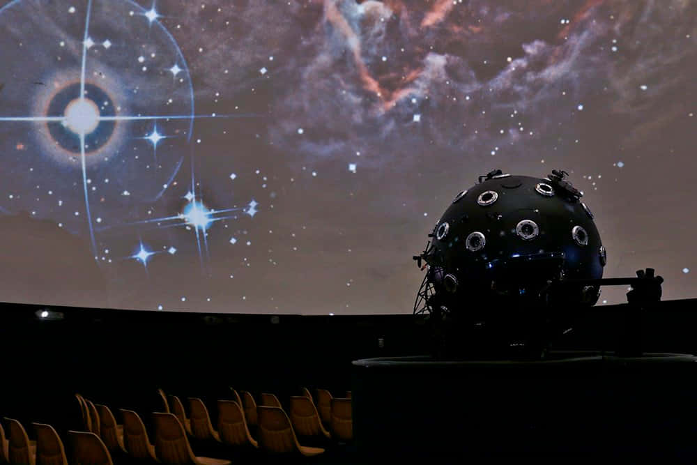 Exploring The Cosmos At The Planetarium Wallpaper