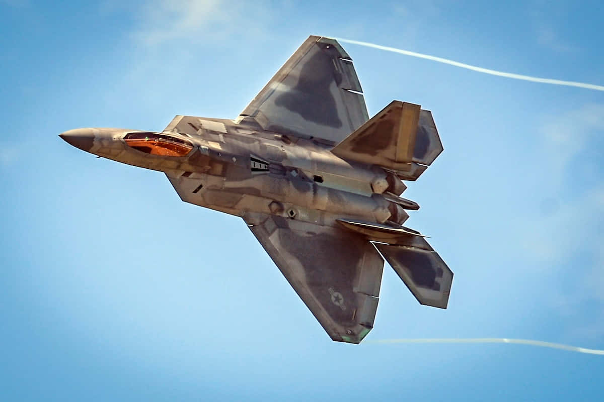 F-22 Raptor Soaring Through The Sky Wallpaper