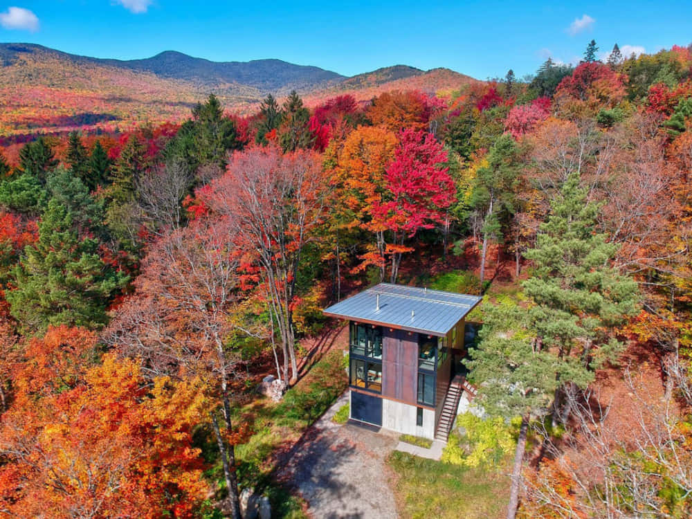 Fall Cabin In A Serene Landscape Wallpaper