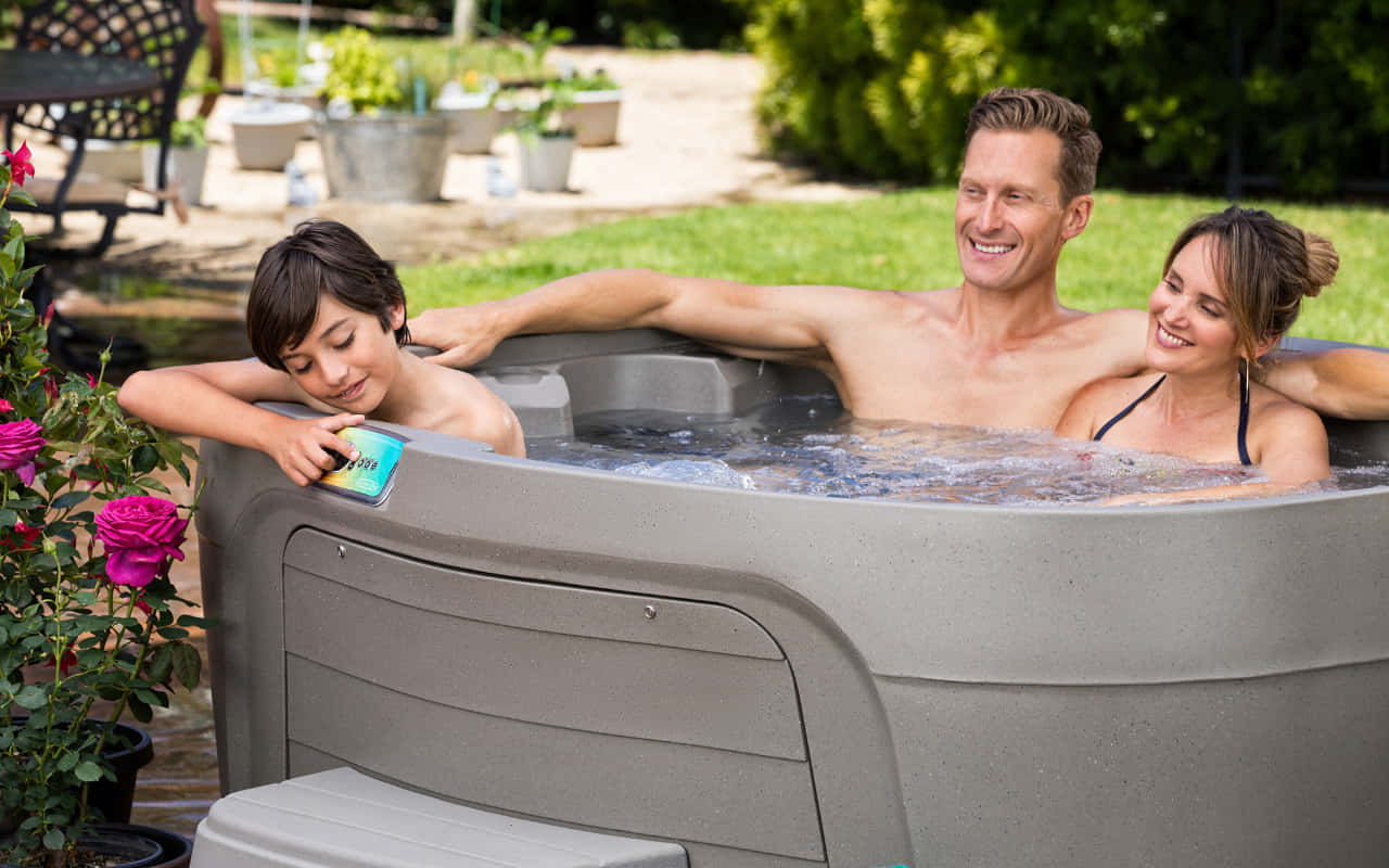 Family Enjoying Outdoor Hot Tub Wallpaper