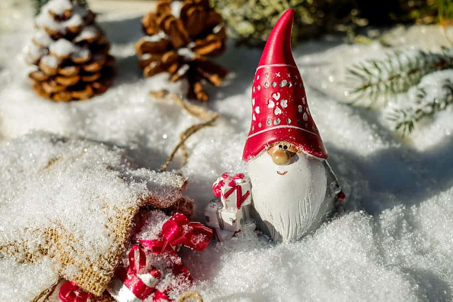 Festive Christmas Gnome Sitting On A Snowy Window Sill Wallpaper