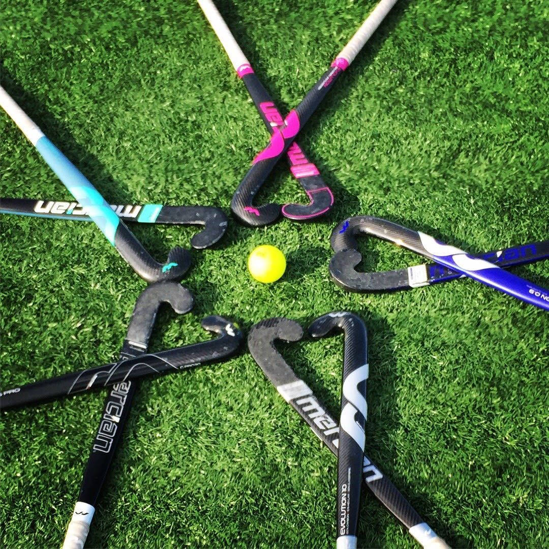 Field Hockey Sticks Under The Sun Wallpaper