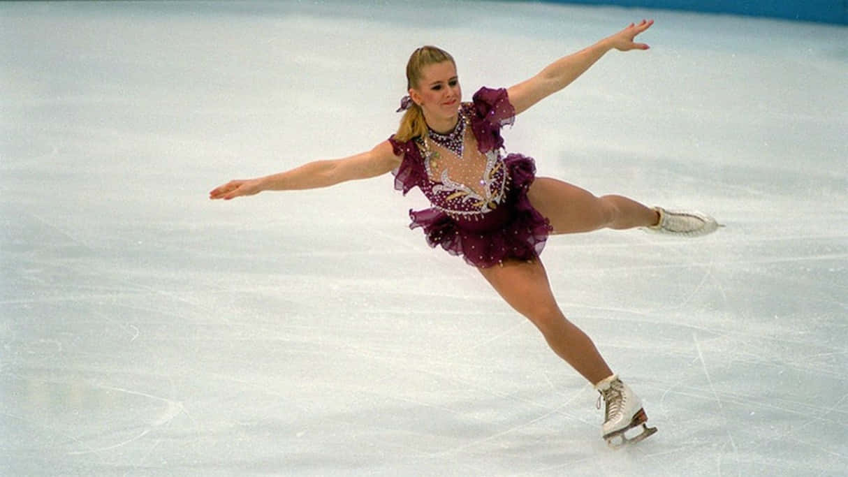 Figure Skater In Purple Dress Performing Wallpaper