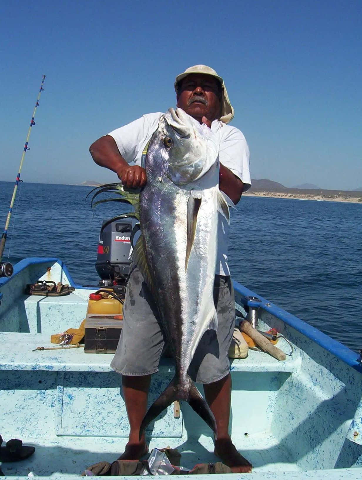 Fishermanwith Giant Roosterfish Catch Wallpaper