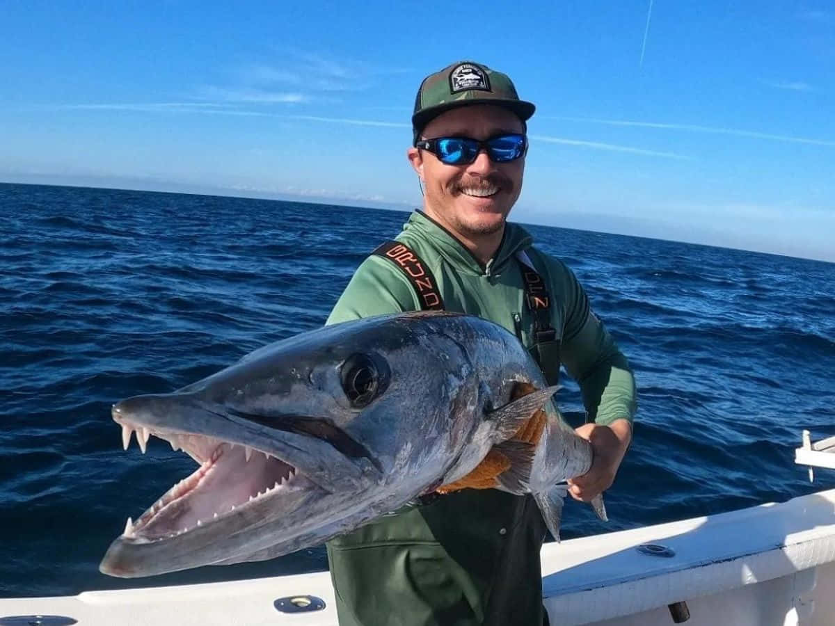 Fishermanwith Large Barracuda Catch Wallpaper