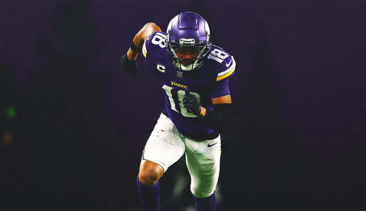 Focused Football Playerin Action Wallpaper