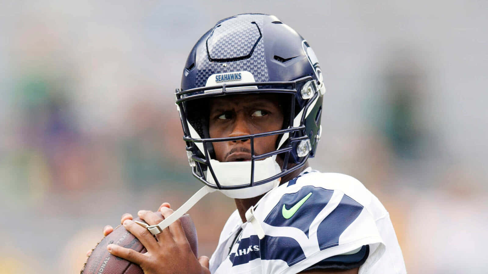 Focused Seahawks Quarterback Preparingfor Play Wallpaper