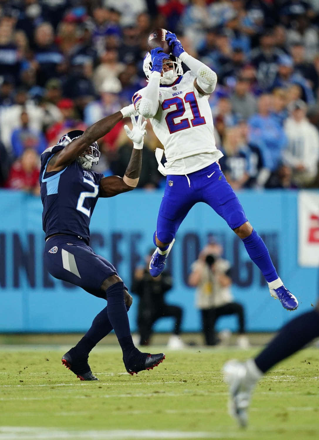 Football Athlete Mid Air Catch Wallpaper