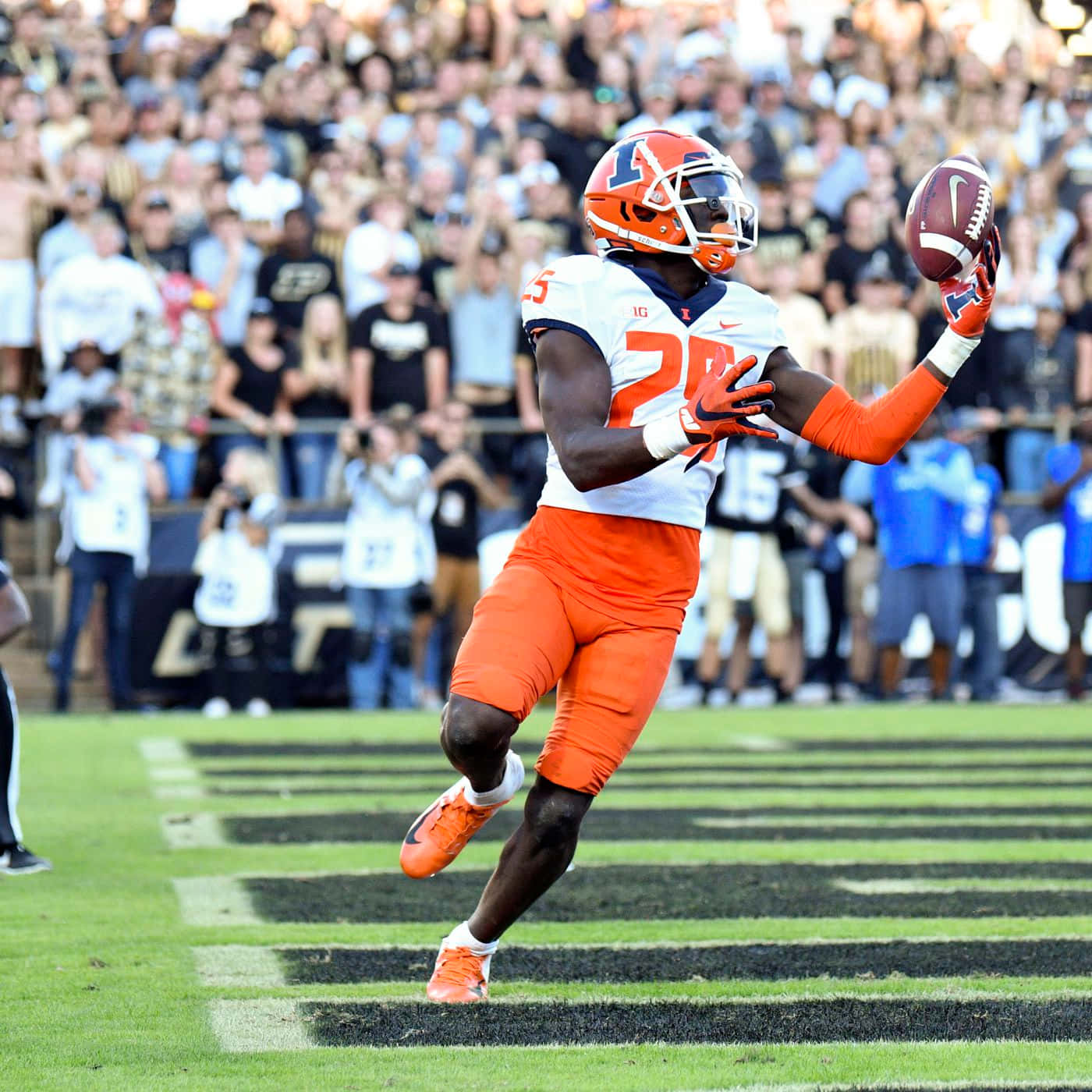 Football Player Catching Ball During Game Wallpaper