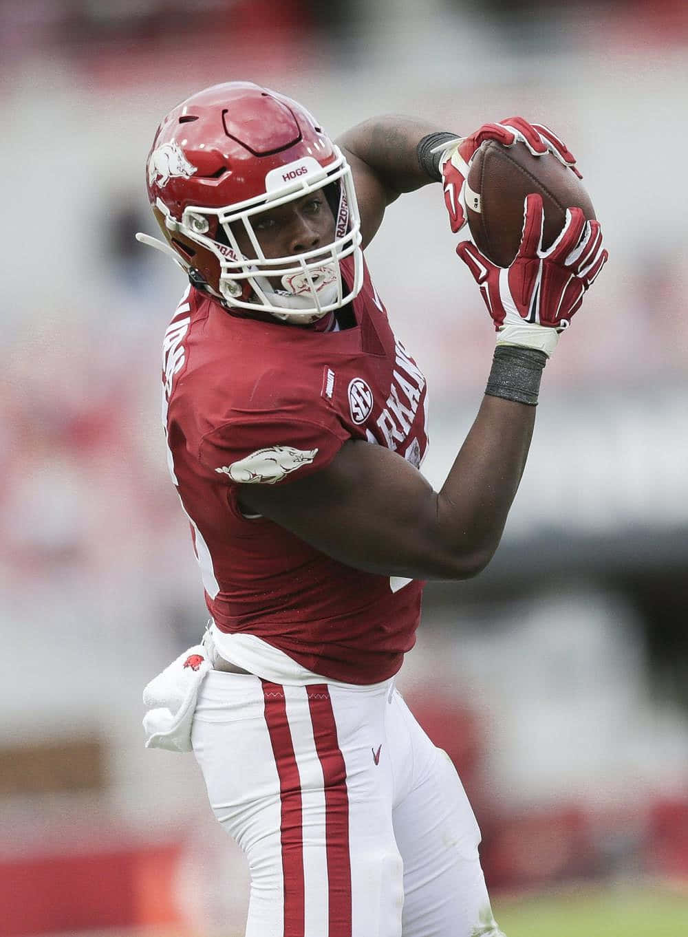 Football Player Catching Ball During Game Wallpaper