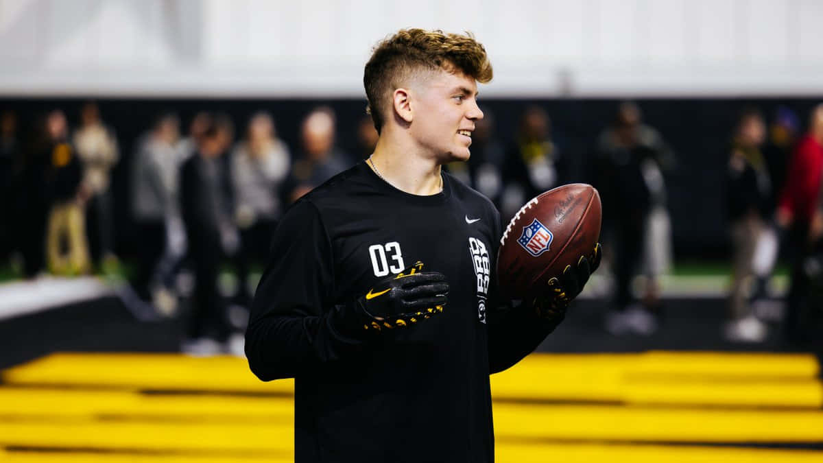 Football Player Holding Ball During Training Wallpaper