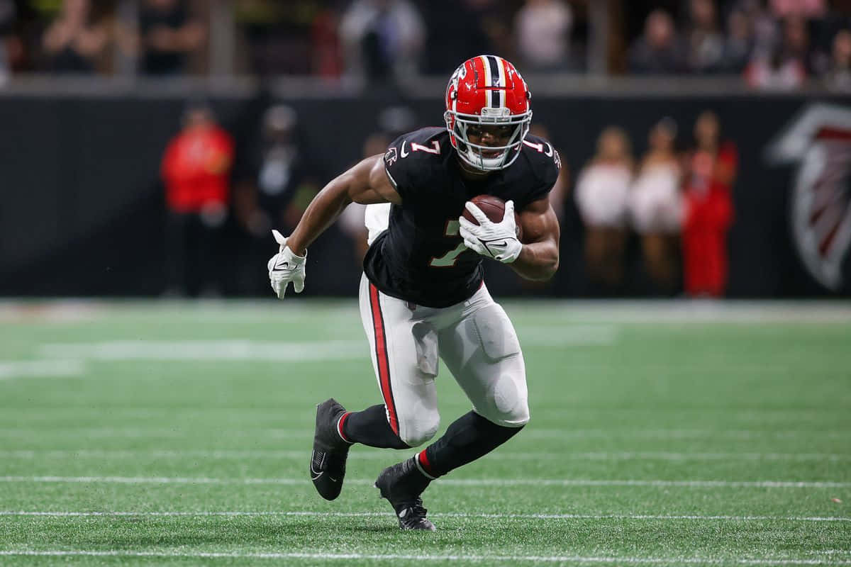 Football Player In Action Running With Ball Wallpaper