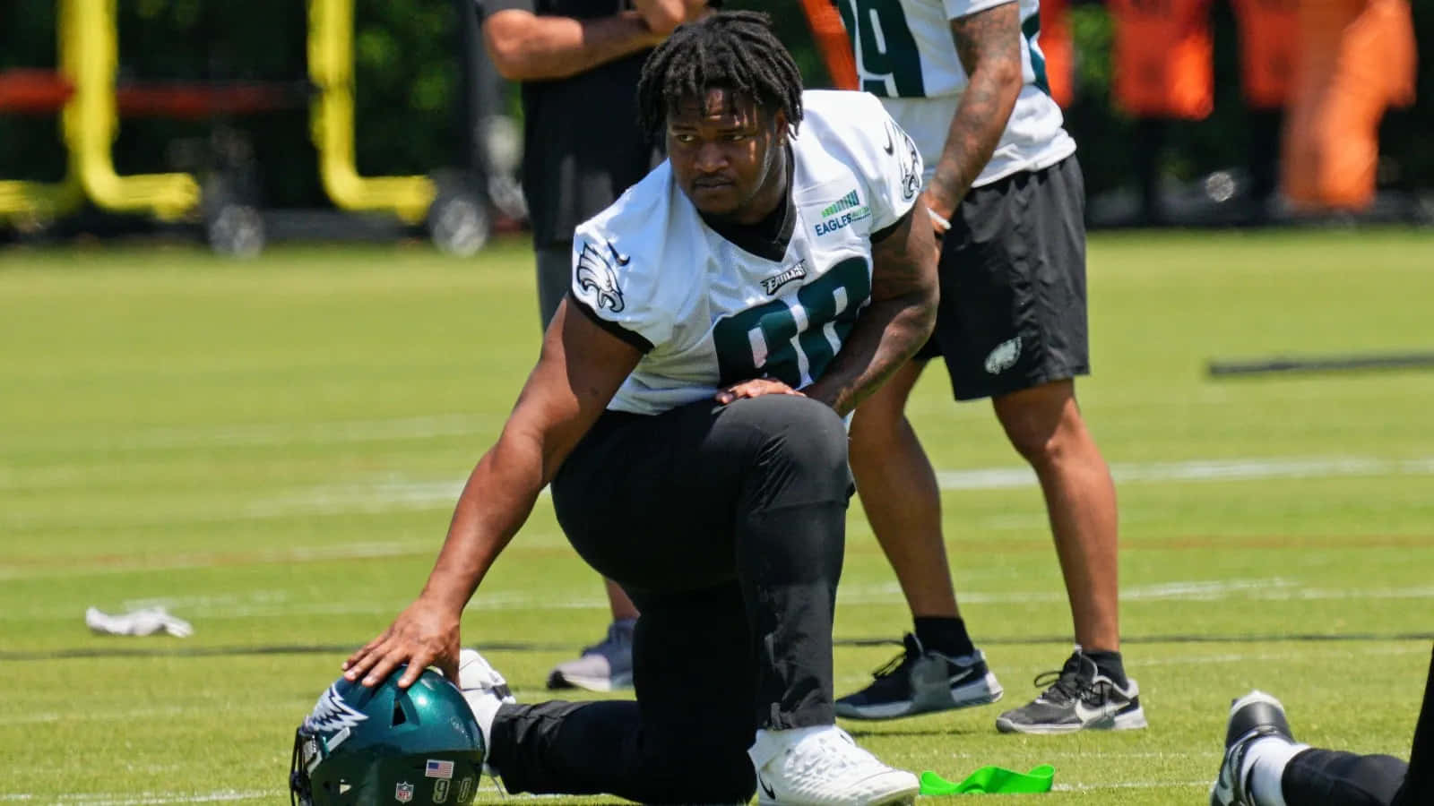 Football Player Kneeling During Practice Wallpaper