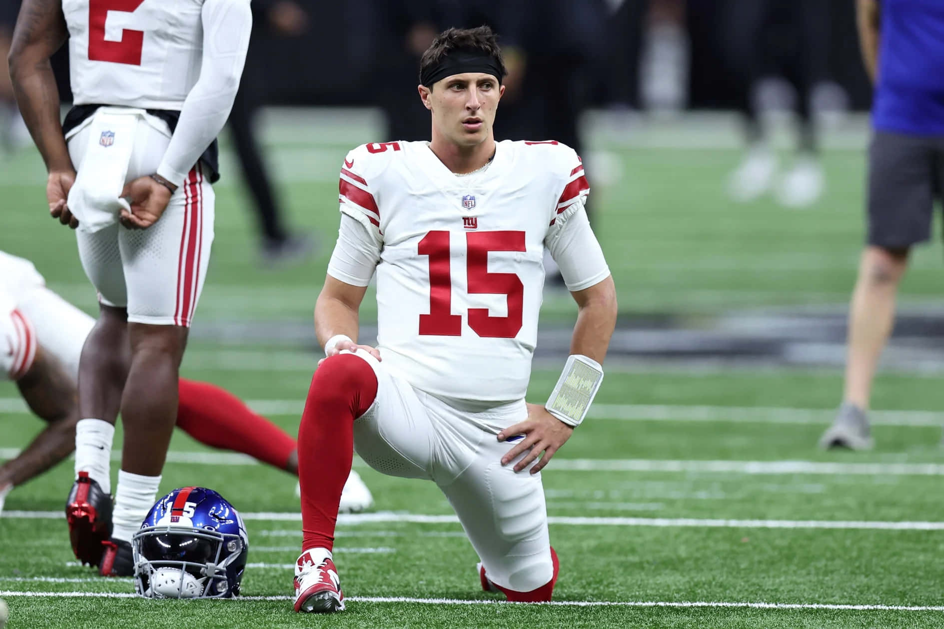 Football Player Kneeling During Warmup Wallpaper