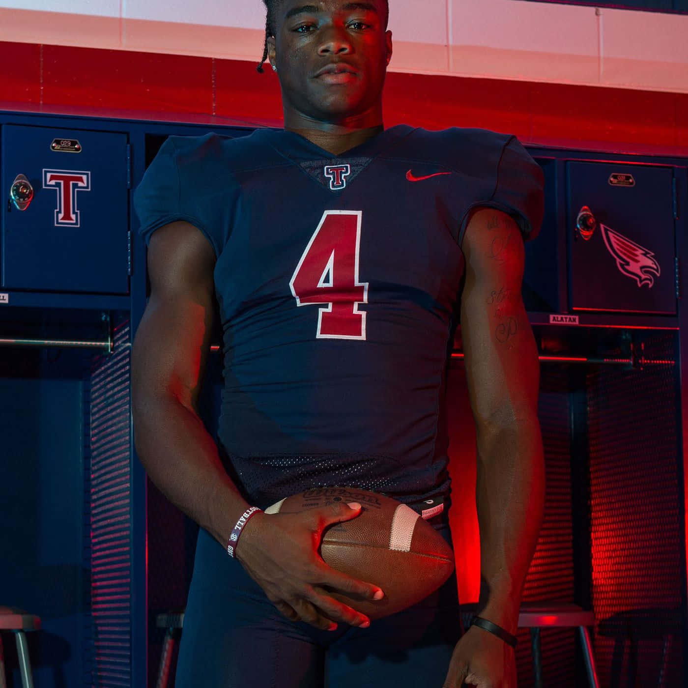 Football Player Number4 Locker Room Pose Wallpaper