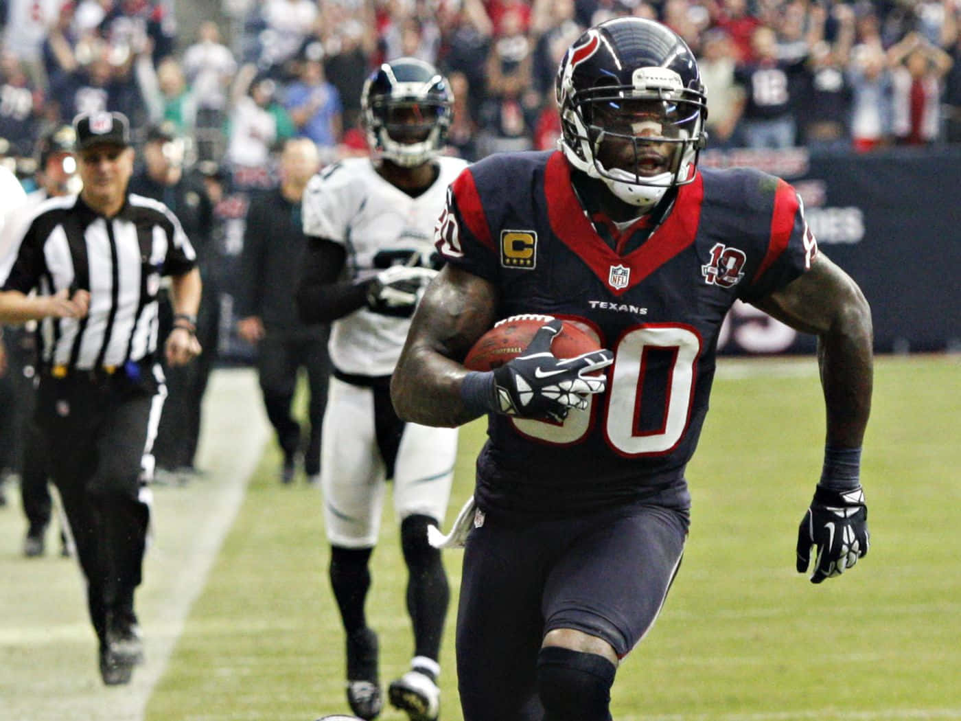 Football Player Running With Ball During Game Wallpaper