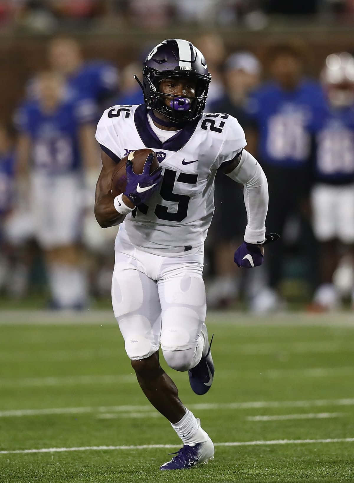 Football Player Running With Ball During Game Wallpaper