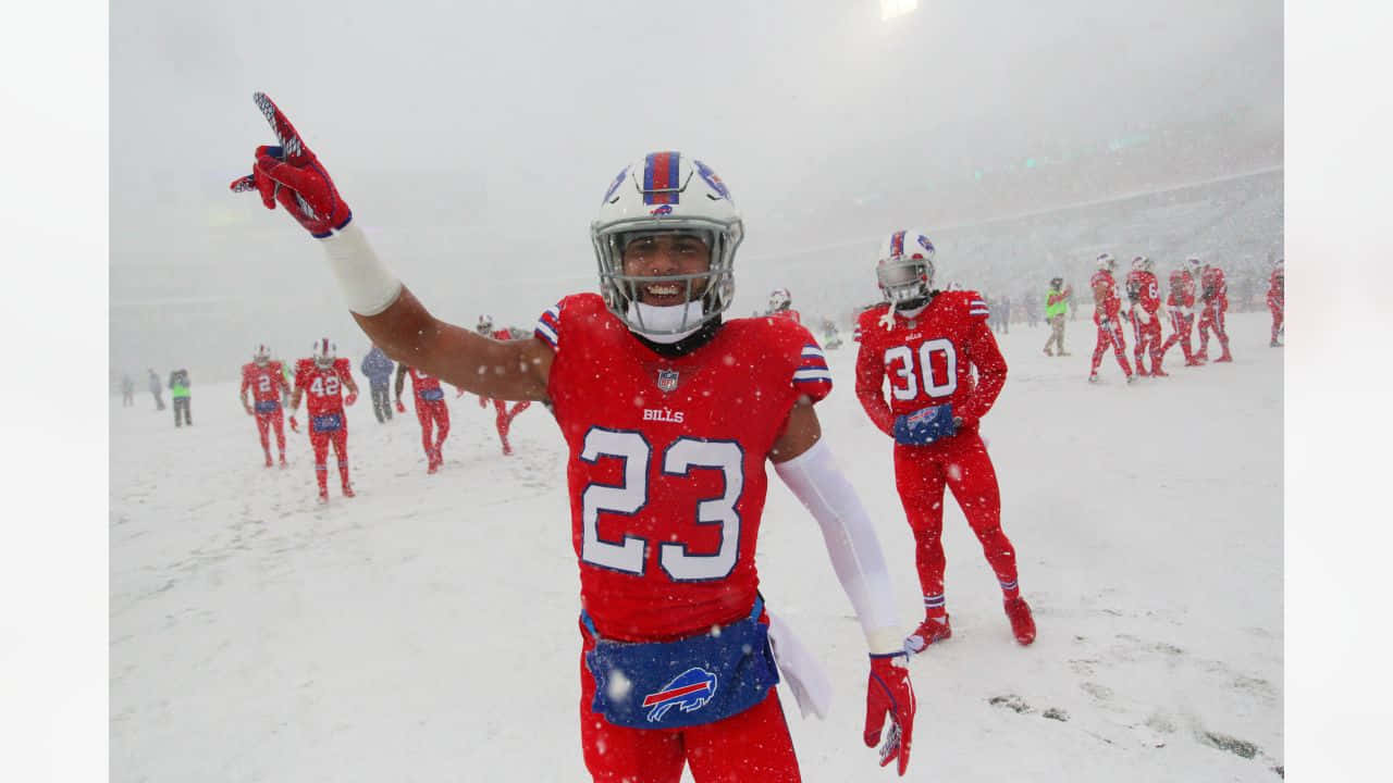 Football Player Snow Game Celebration Wallpaper