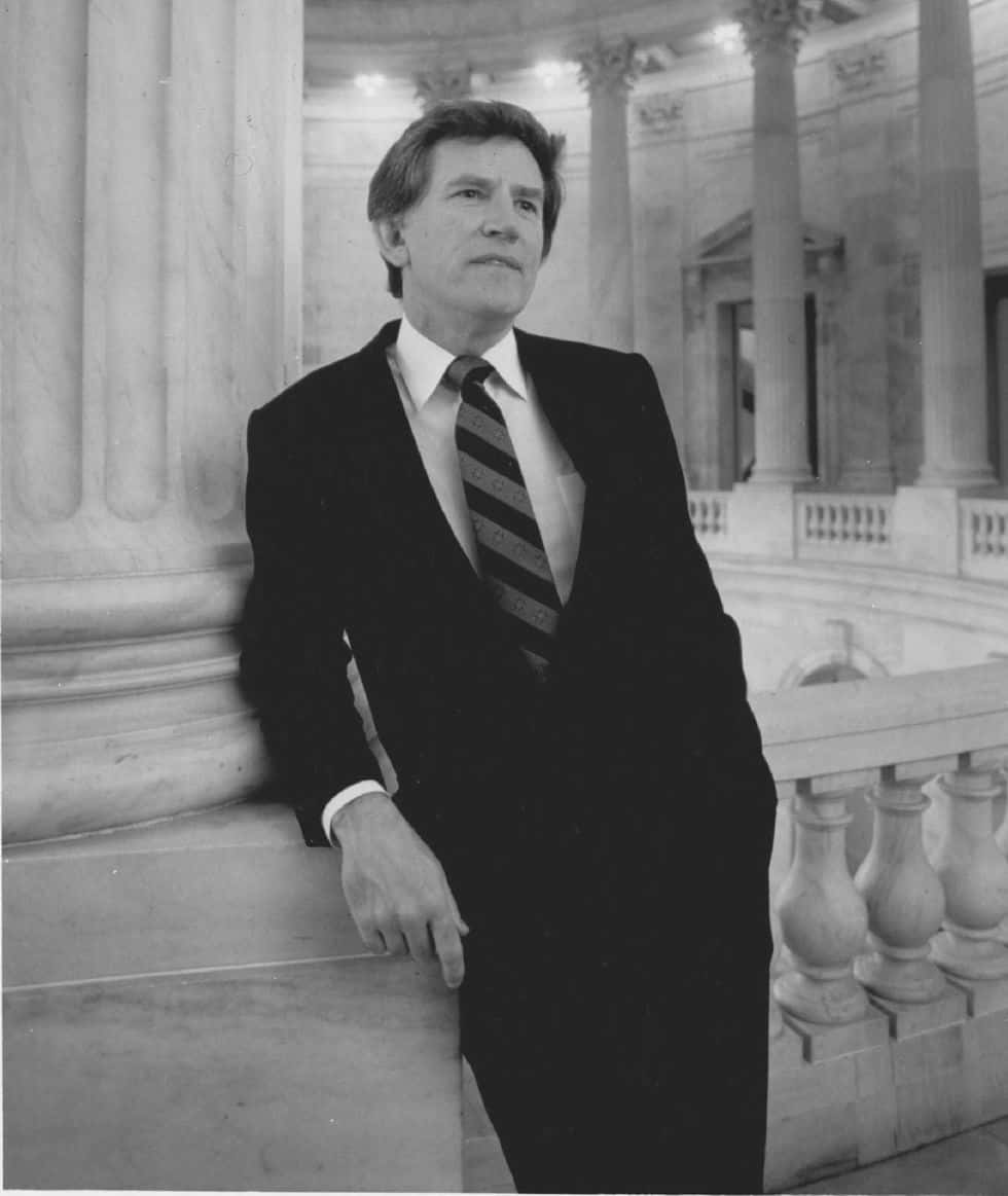 Former Senator Gary Hart Leaning On A Column Wallpaper