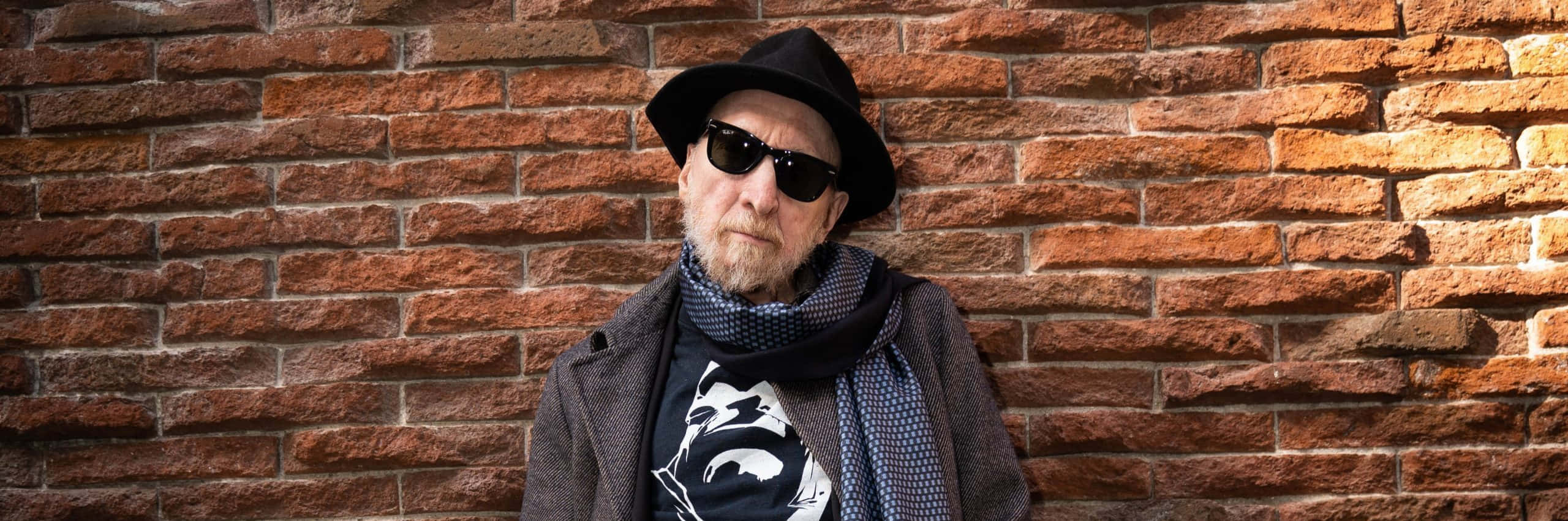 Frank Miller Standing With His Artwork In The Background Wallpaper