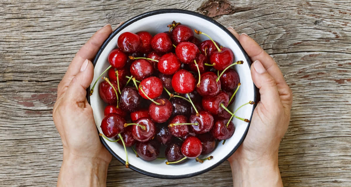 Fresh And Vibrant Red Cherries Wallpaper